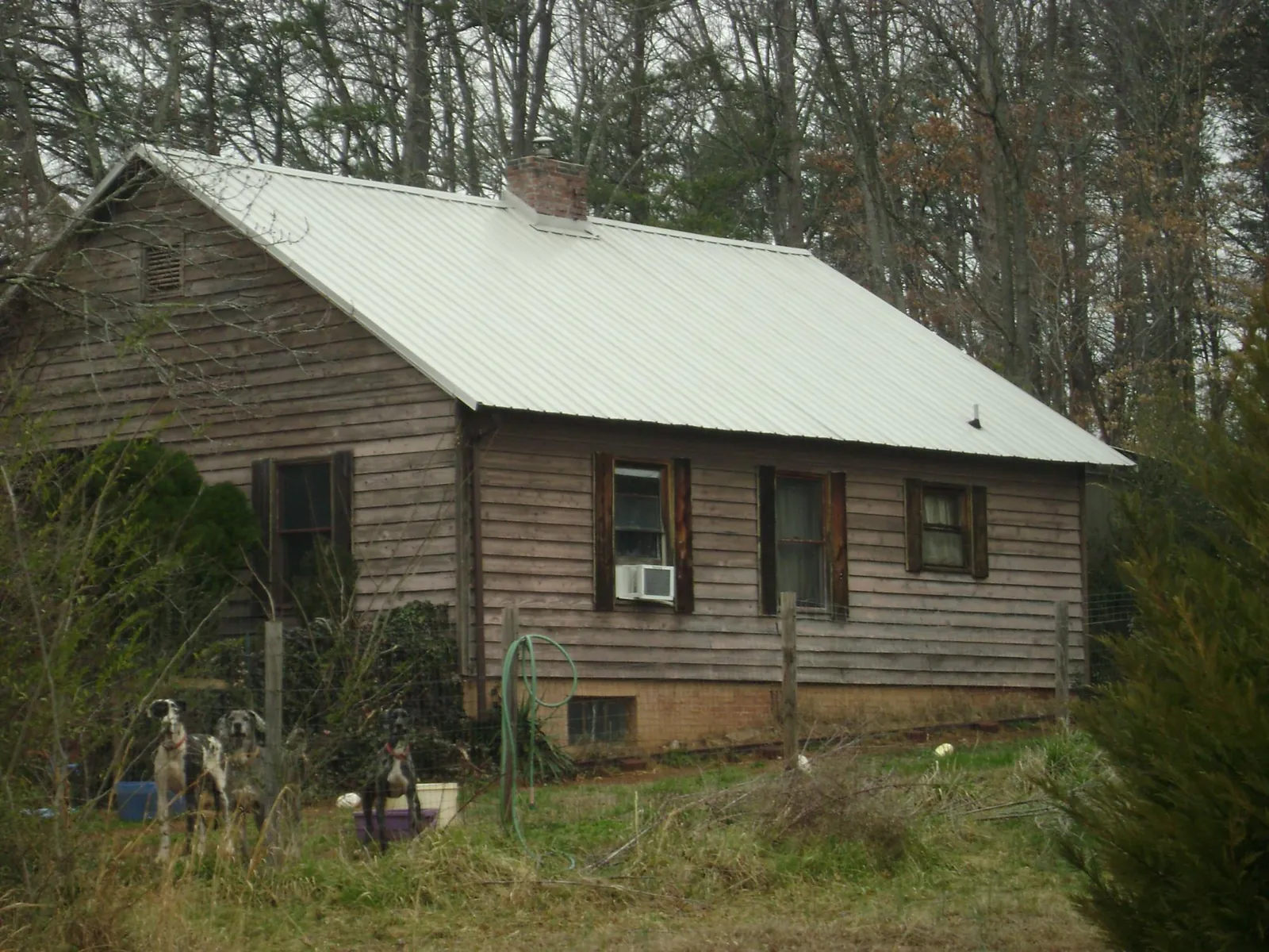 White metal roof on an old wood sided farmhouse, from a Metal Roof Installation job in Sullivan